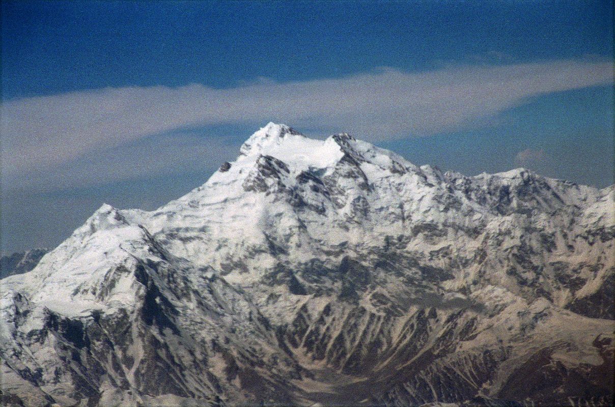 10 Nanga Parbat Rakhiot Face, Rakhiot Peak, Silver Saddle, East Peak, Silver Plateau, Summit, North Peaks On Flight From Islamabad To Skardu On the 40-minute flight from Islamabad to Skardu, the captain announces, �We'll be flying at a planned altitude of 8,000 metres.� Perfect I thought, we'll be exactly at the height of Nanga Parbat. The flight starts low key with the stewardesses serving drinks while we bide our time. When the pilot announces �Nanga Parbat is immediately ahead on the right�, all hell breaks loose. As one, all the tourists, including me, are up in the aisles, craning their necks, running for the cockpit. The sounds of cameras are everywhere. There it is, within arm�s reach. Nanga Parbat in perfect early morning splendor! After passing by the Diamir Face, we can see Hermann Buhl�s route of first ascent with the Rakhiot Peak leading up to the Silver Saddle between the Nanga Parbat Southeast and East Peaks, and up to the summit with the North Peaks on the right.
